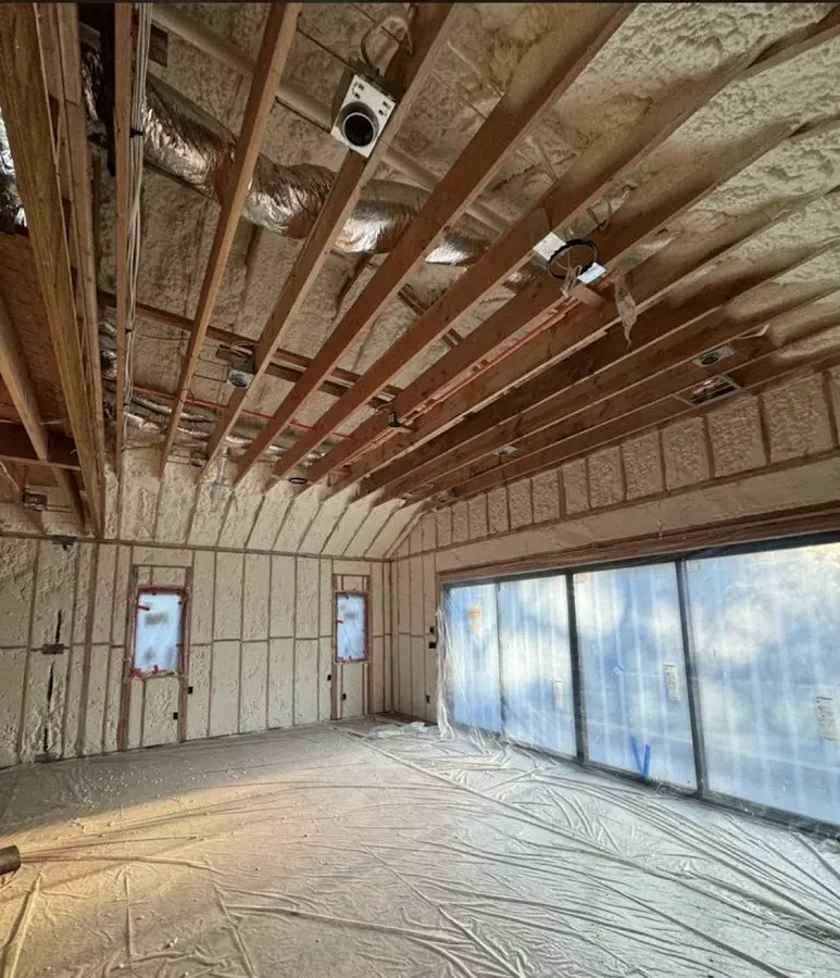 Interior walls and ceiling insulated with spray foam during new construction in Paris